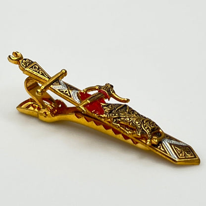 Close-up angled view of Spanish-style vintage tie bar with sword shape