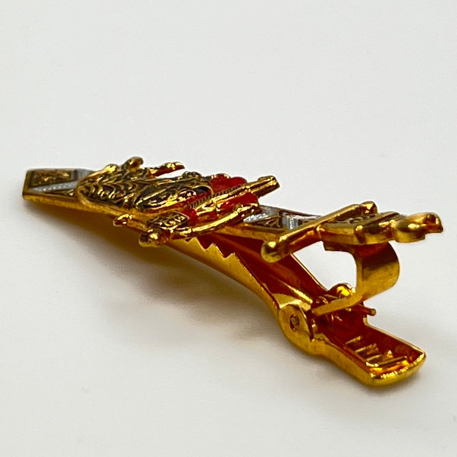 Close-up angled view of Spanish-style vintage tie bar with sword shape