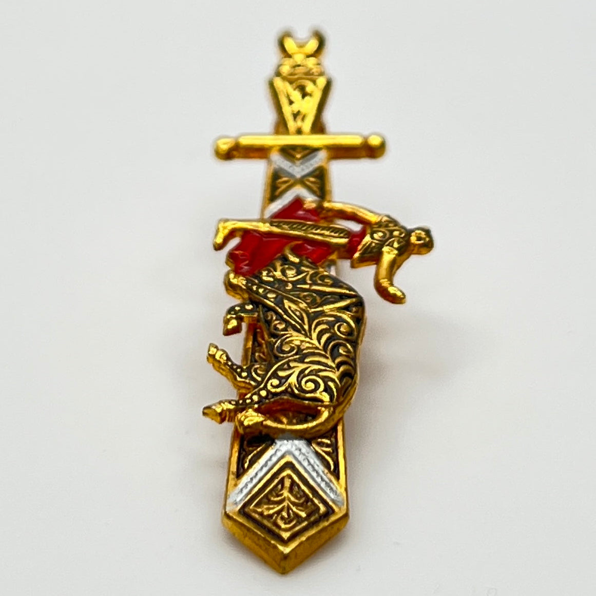 Close-up angled view of Spanish-style vintage tie bar with sword shape