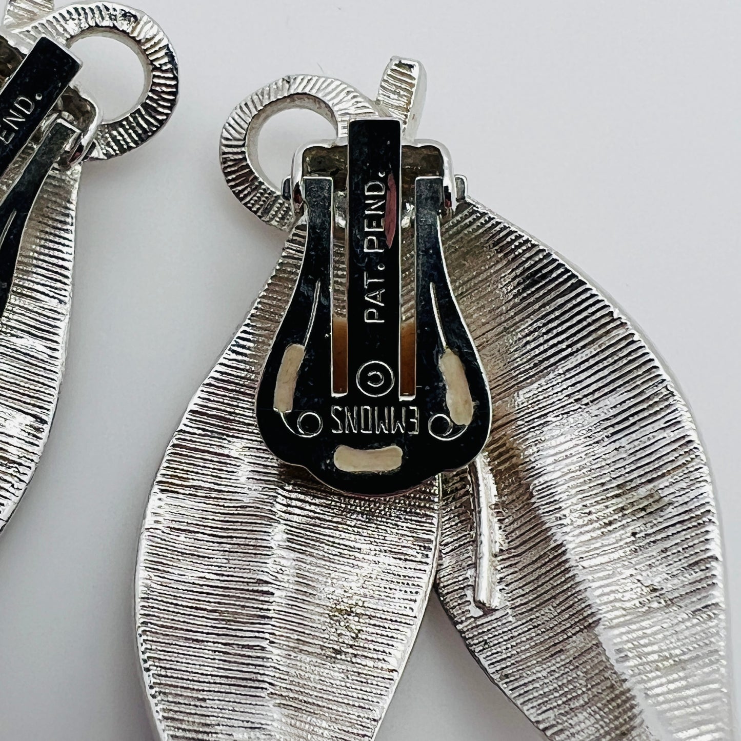 Close-up of Emmons signature on vintage silver leaf earrings