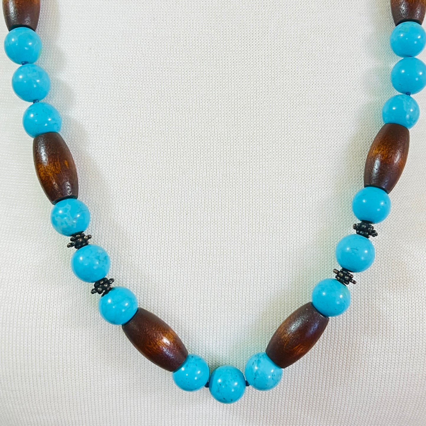 EXEX sterling silver and turquoise necklace with wood beads displayed on mannequin bust