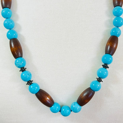 EXEX sterling silver and turquoise necklace with wood beads displayed on mannequin bust