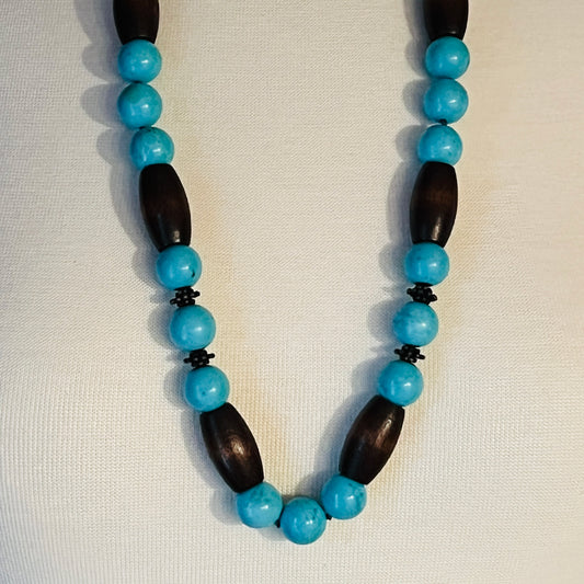 EXEX sterling silver and turquoise necklace with wood beads displayed on mannequin bust