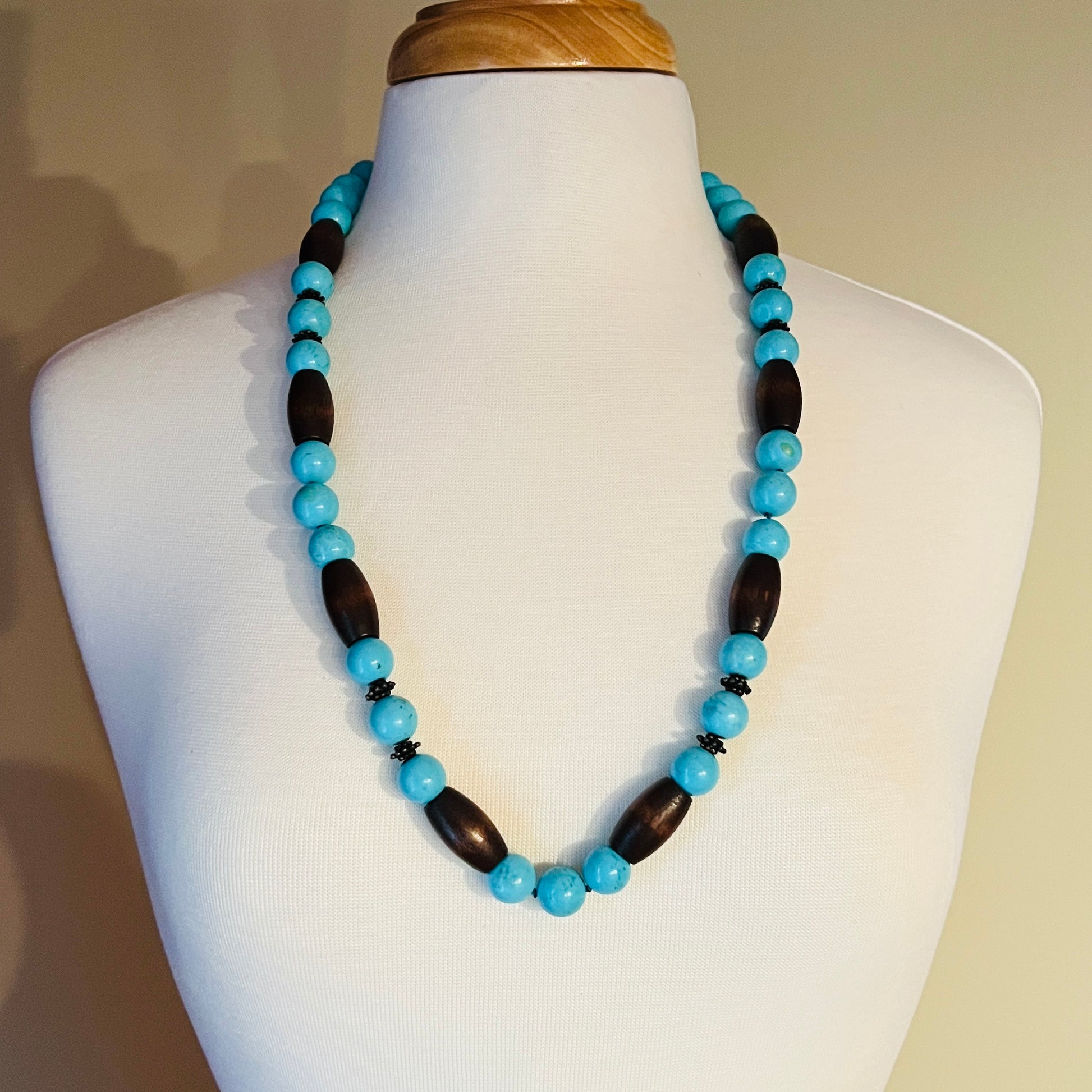 EXEX sterling silver and turquoise necklace with wood beads displayed on mannequin bust