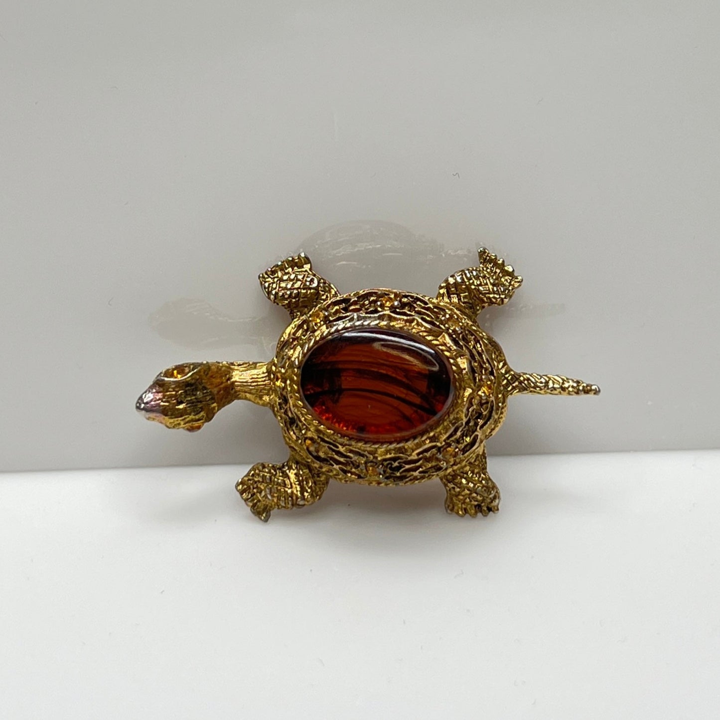 Vintage figural turtle brooch with glass tortoise shell top and filigree gold body