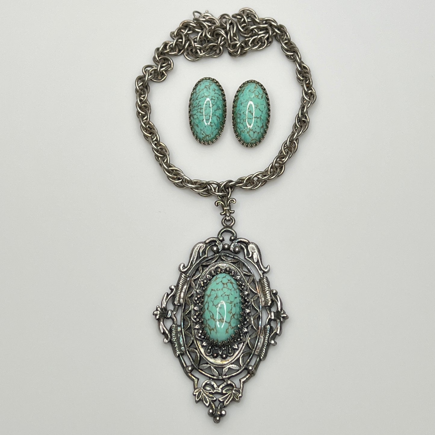 Vintage silver-tone necklace with large faux turquoise pendant and matching earrings