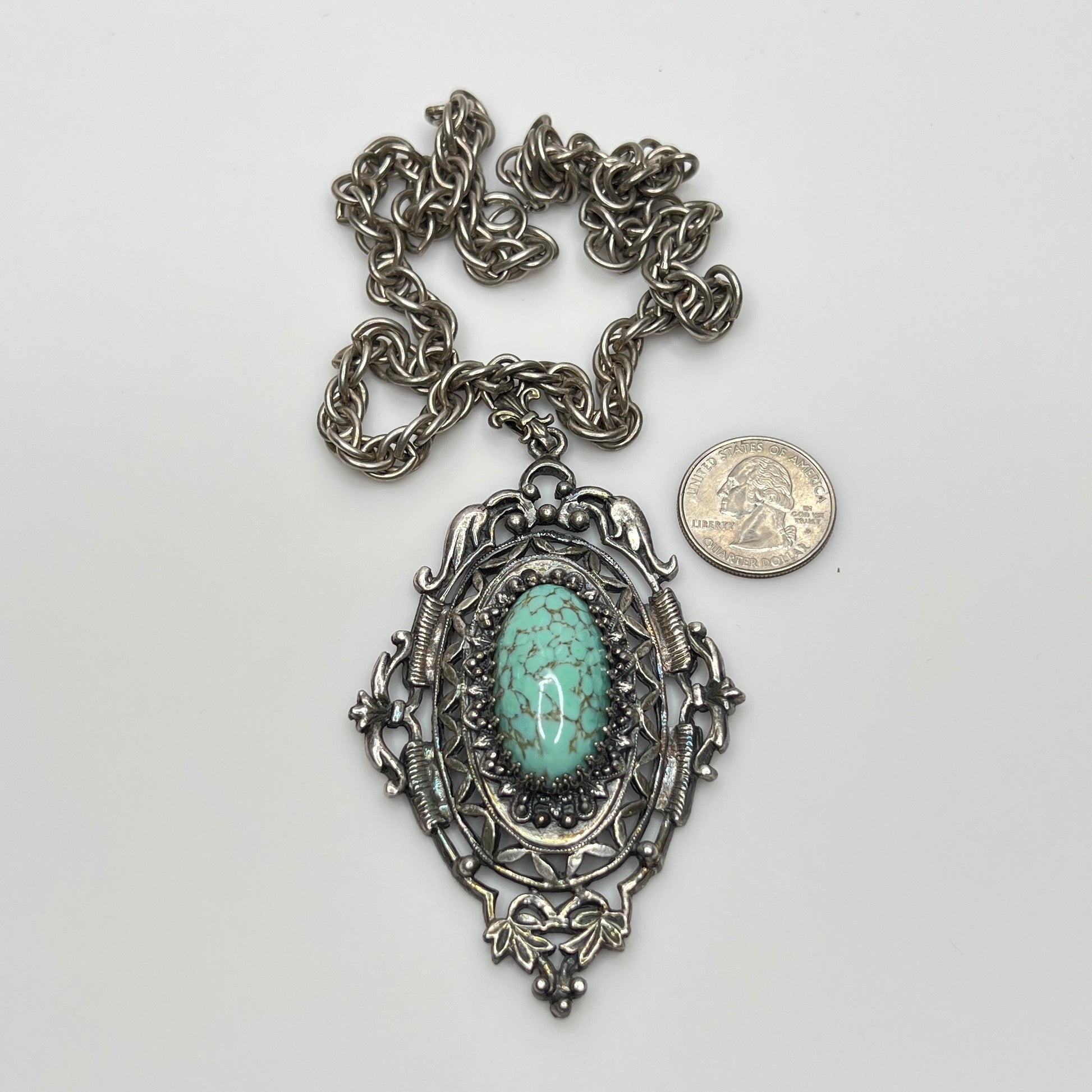 Ornate Victorian Revival pendant with oval faux turquoise cabochon