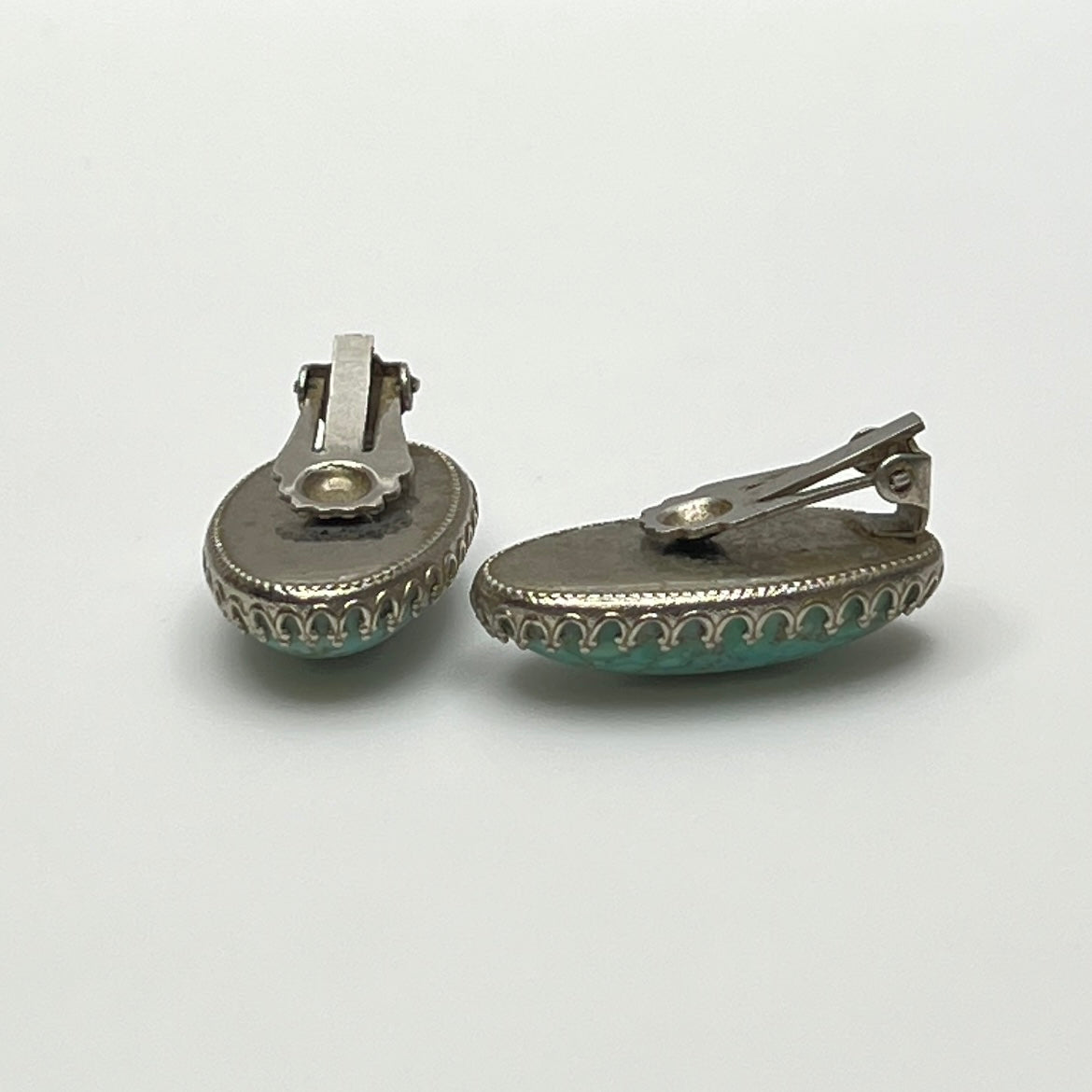 Clip-on earrings with crackled turquoise-style cabochons in silver setting