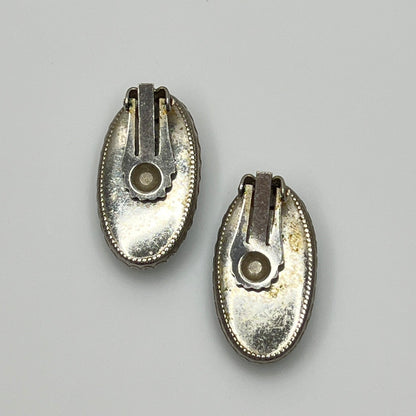Clip-on earrings with crackled turquoise-style cabochons in silver setting