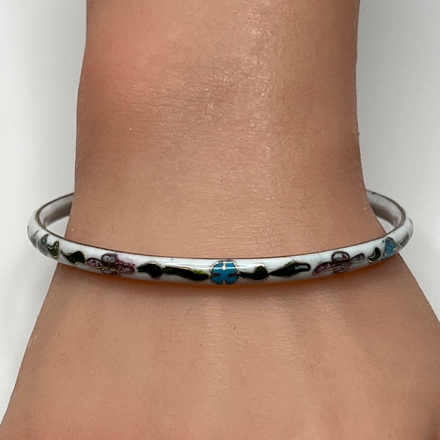 Skinny 1970s enamel bracelet in boho style on wrist