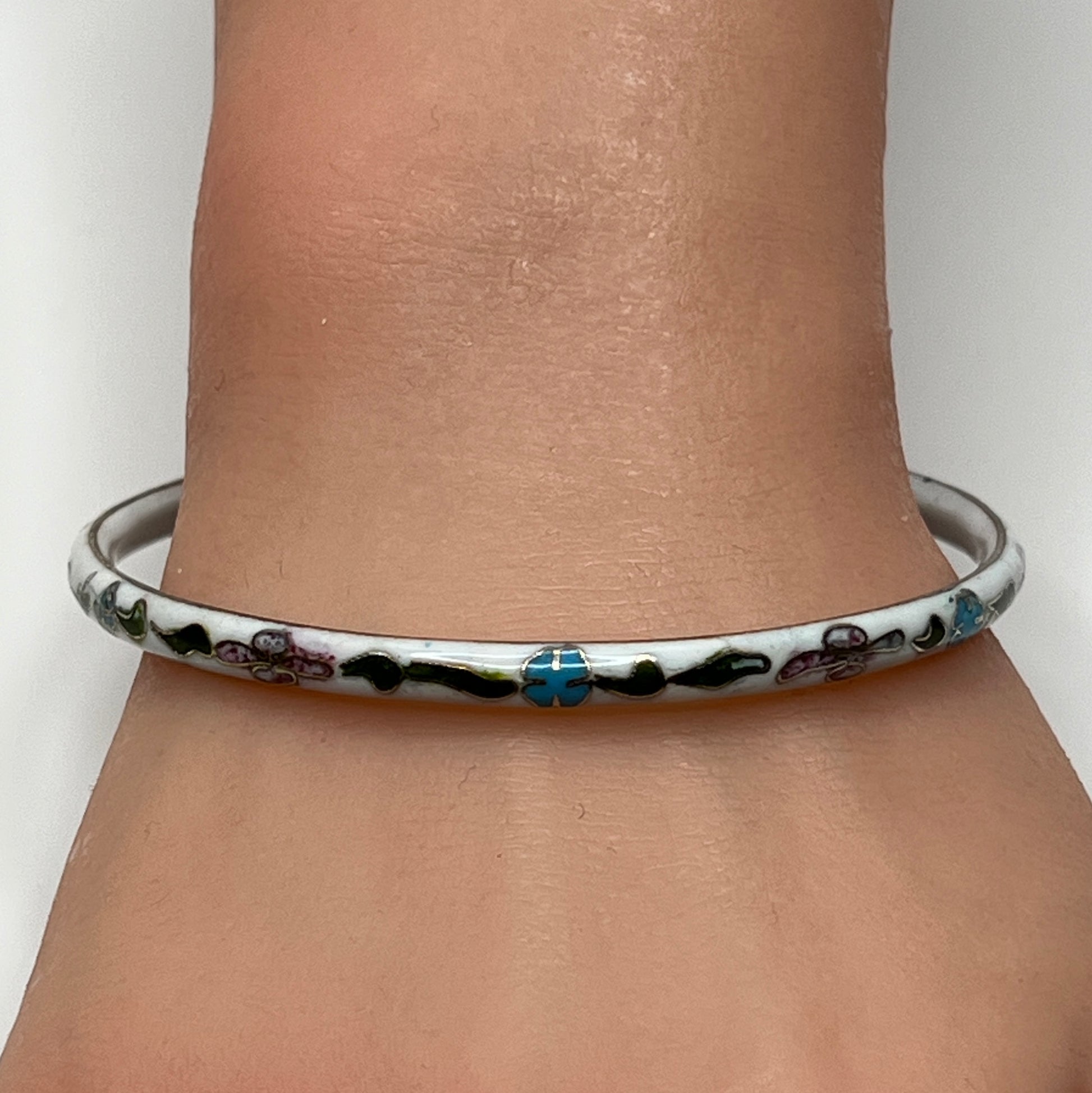 Skinny 1970s enamel bracelet in boho style on wrist