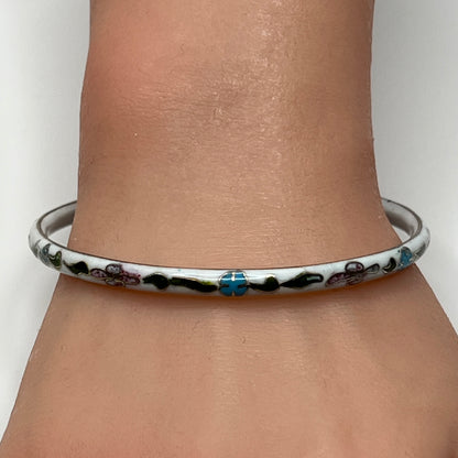 Skinny 1970s enamel bracelet in boho style on wrist