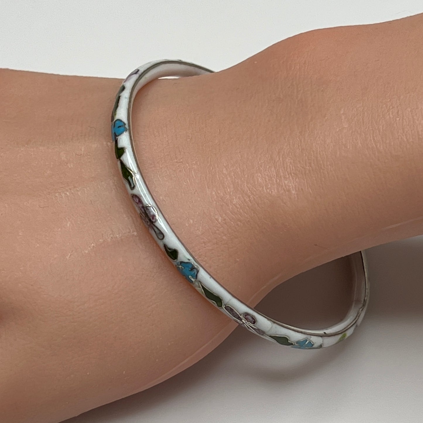 Skinny 1970s enamel bracelet in boho style on wrist