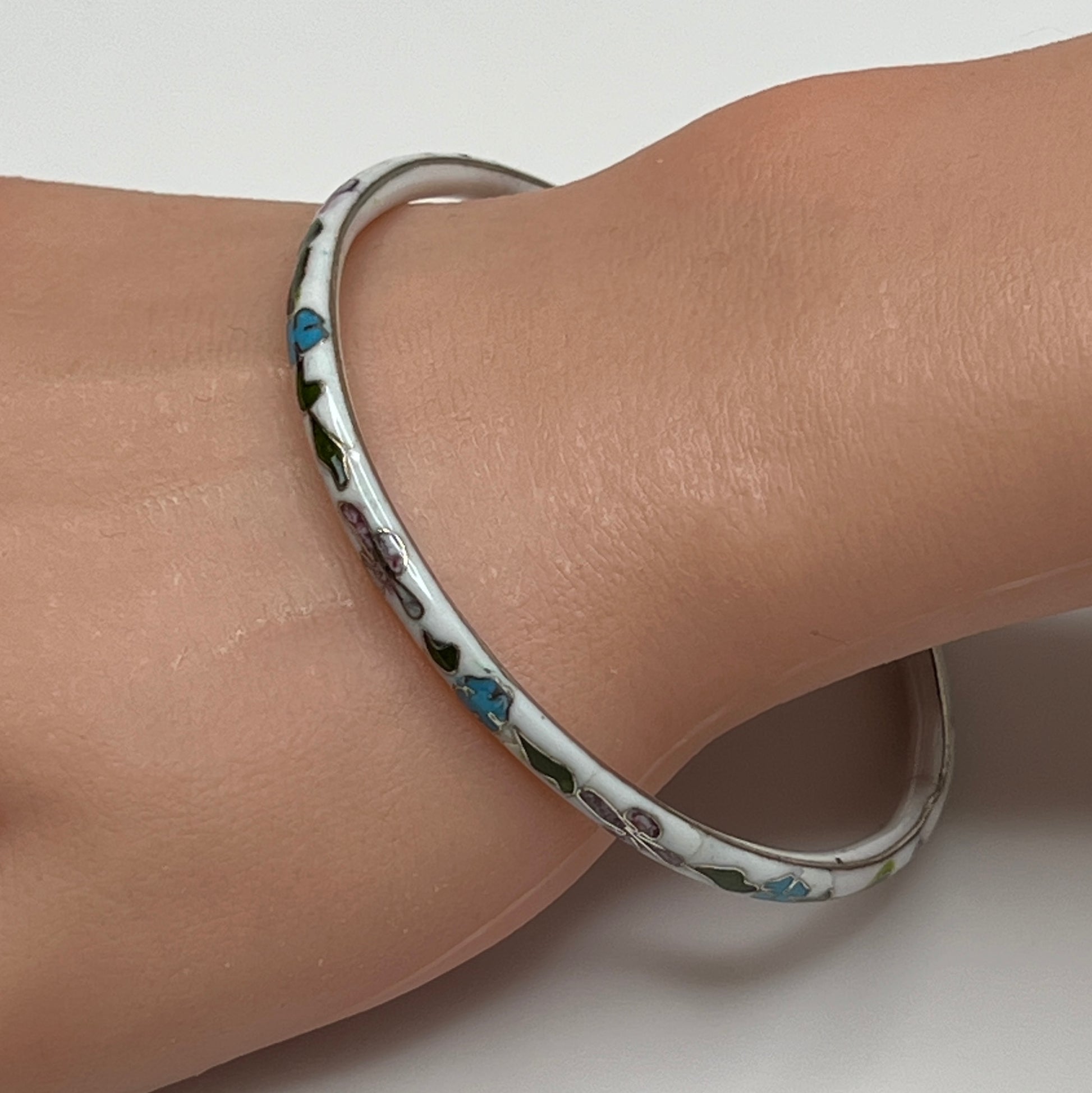 Skinny 1970s enamel bracelet in boho style on wrist