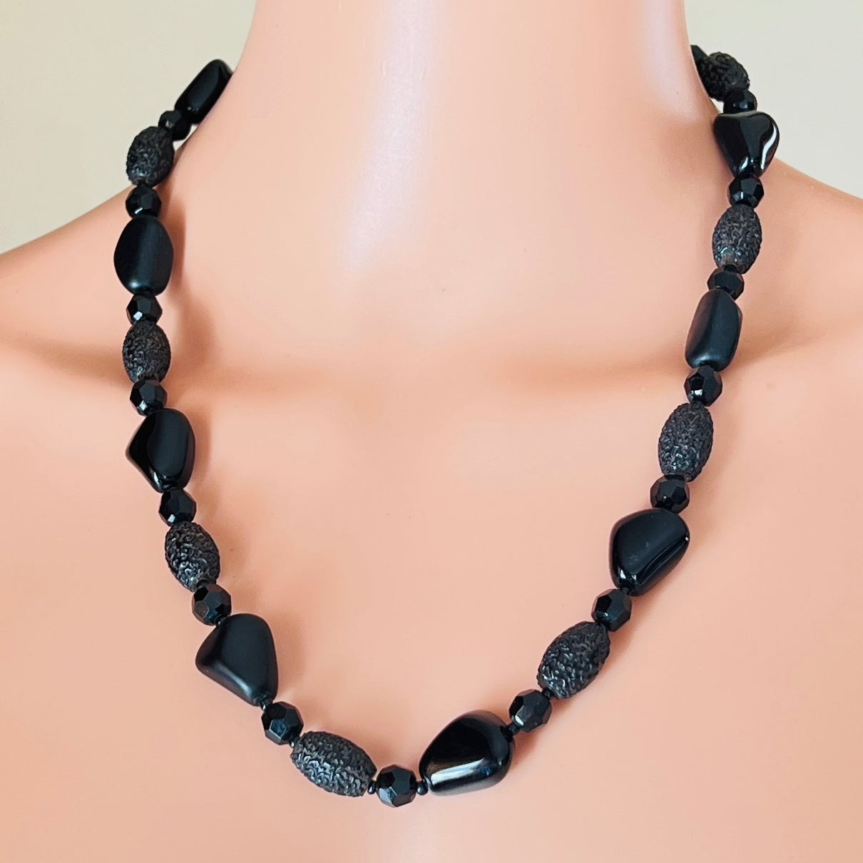 Geometric black glass bead necklace with textured and glossy finishes