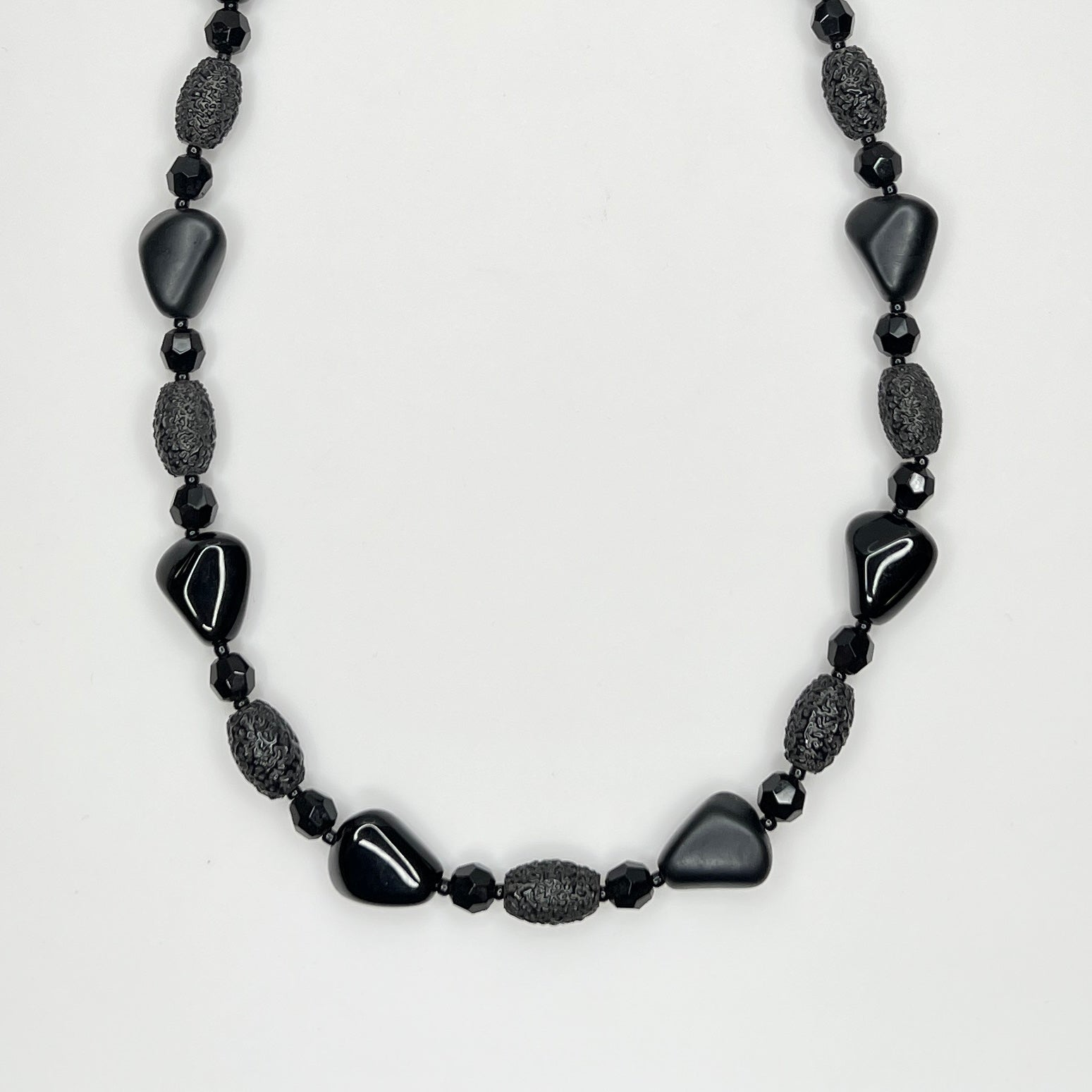 Geometric black glass bead necklace with textured and glossy finishes