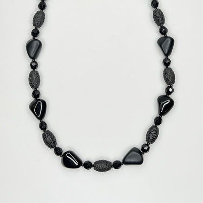 Geometric black glass bead necklace with textured and glossy finishes