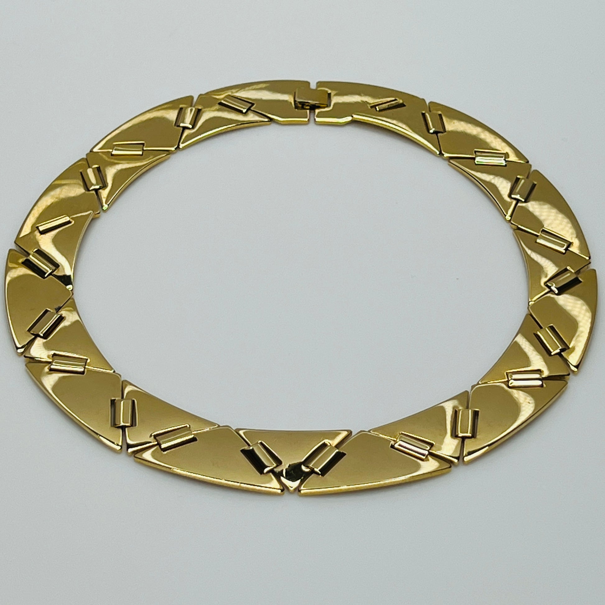 Gold geometric statement necklace with architectural flair