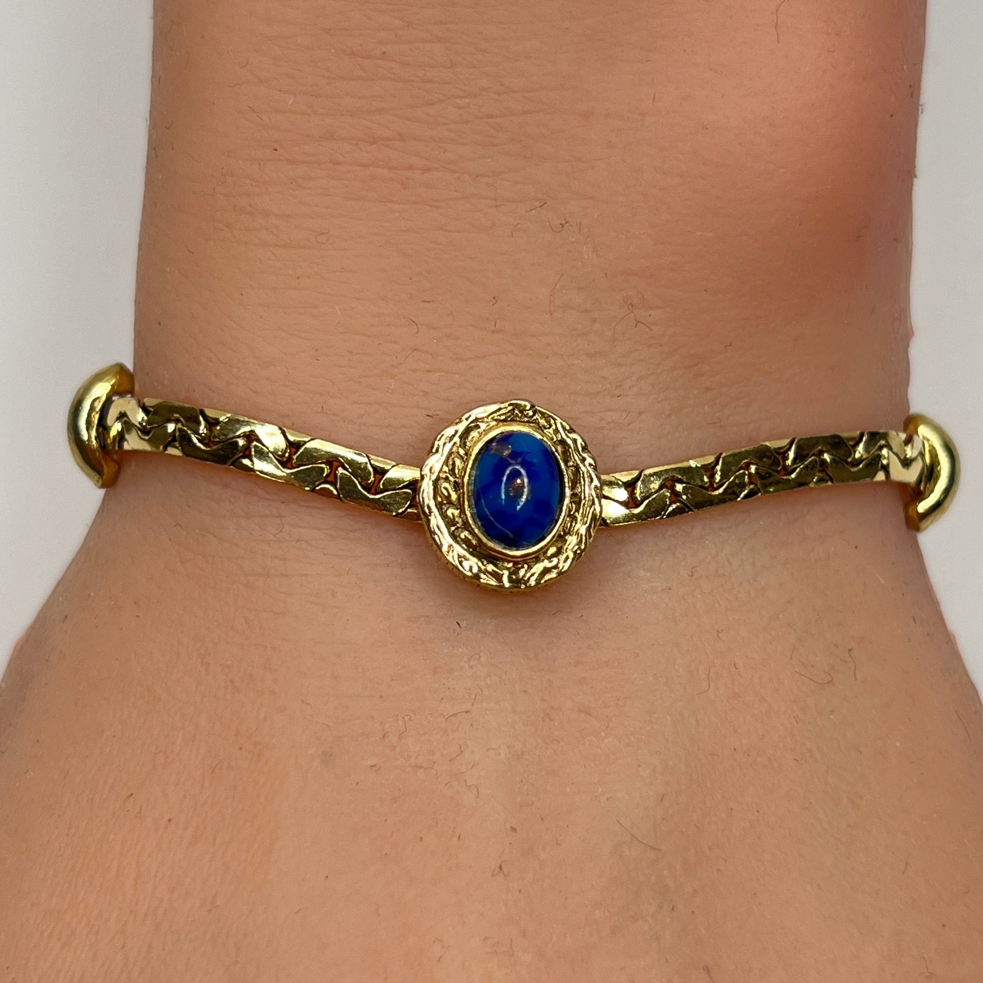 Goldette bracelet with lapis blue cabochon on wrist