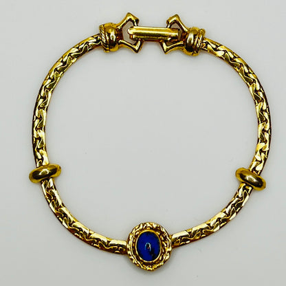 Full view of gold-tone bracelet with fold-over clasp