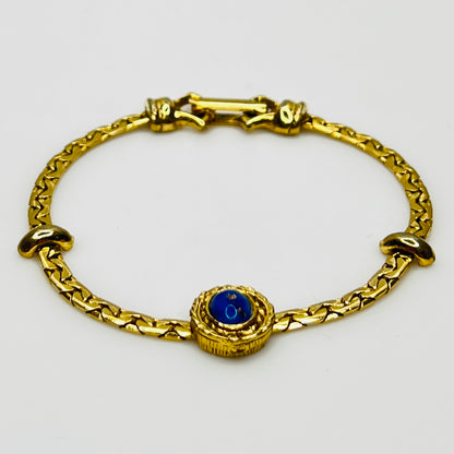 Full view of gold-tone bracelet with fold-over clasp