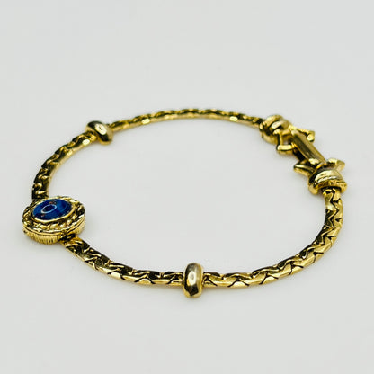 Full view of gold-tone bracelet with fold-over clasp