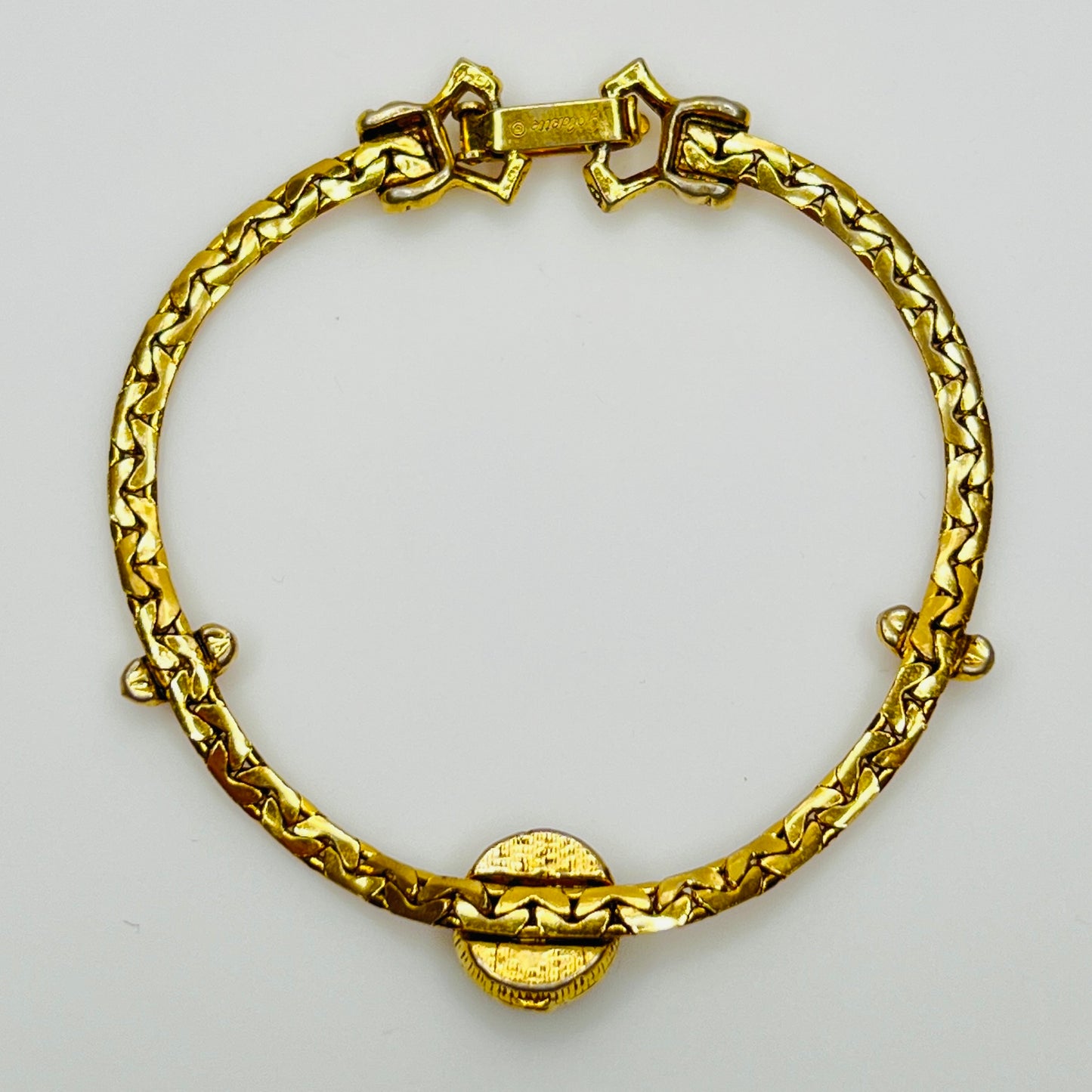 Full back view of gold-tone bracelet with fold-over clasp