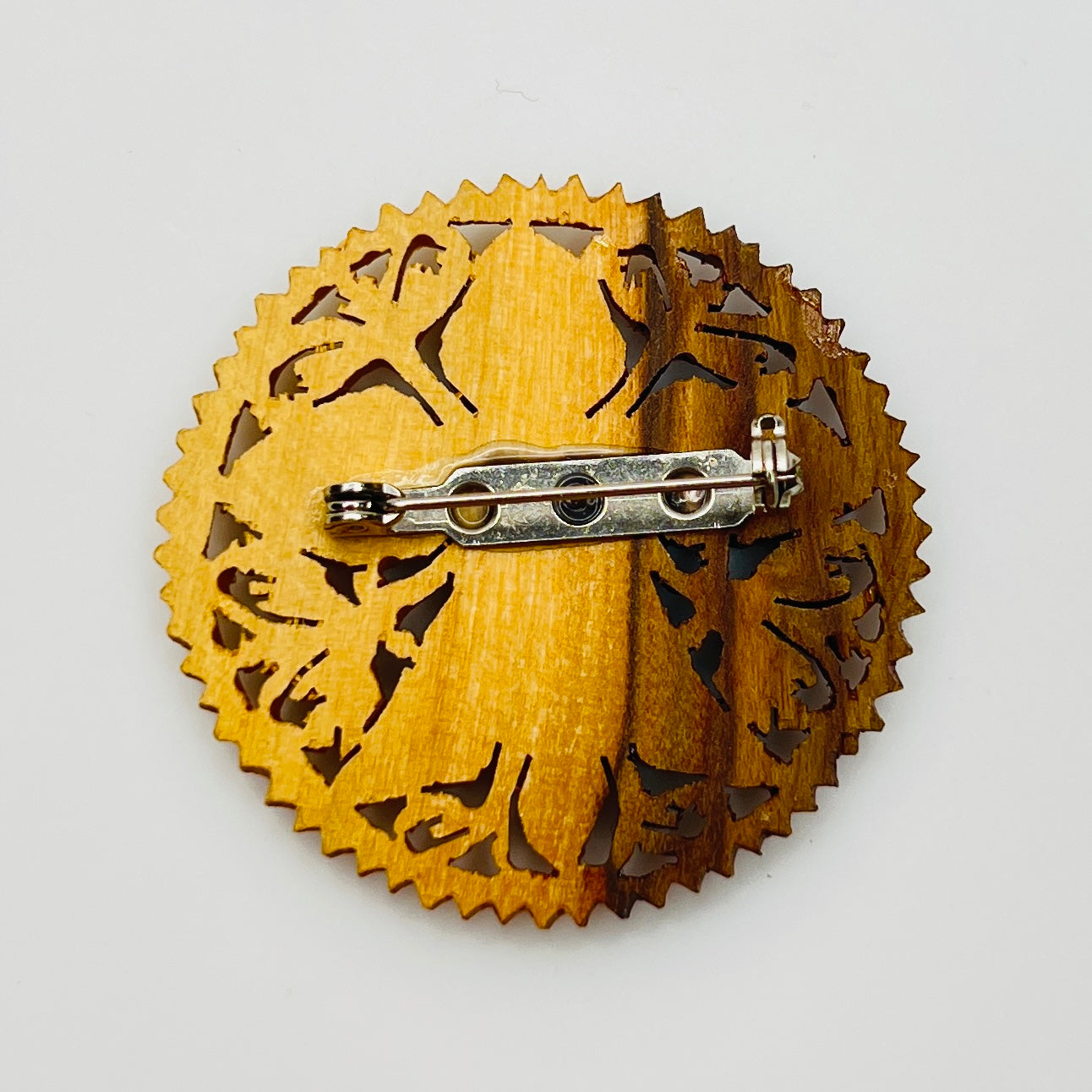 Carved wooden floral pin in honey brown tones