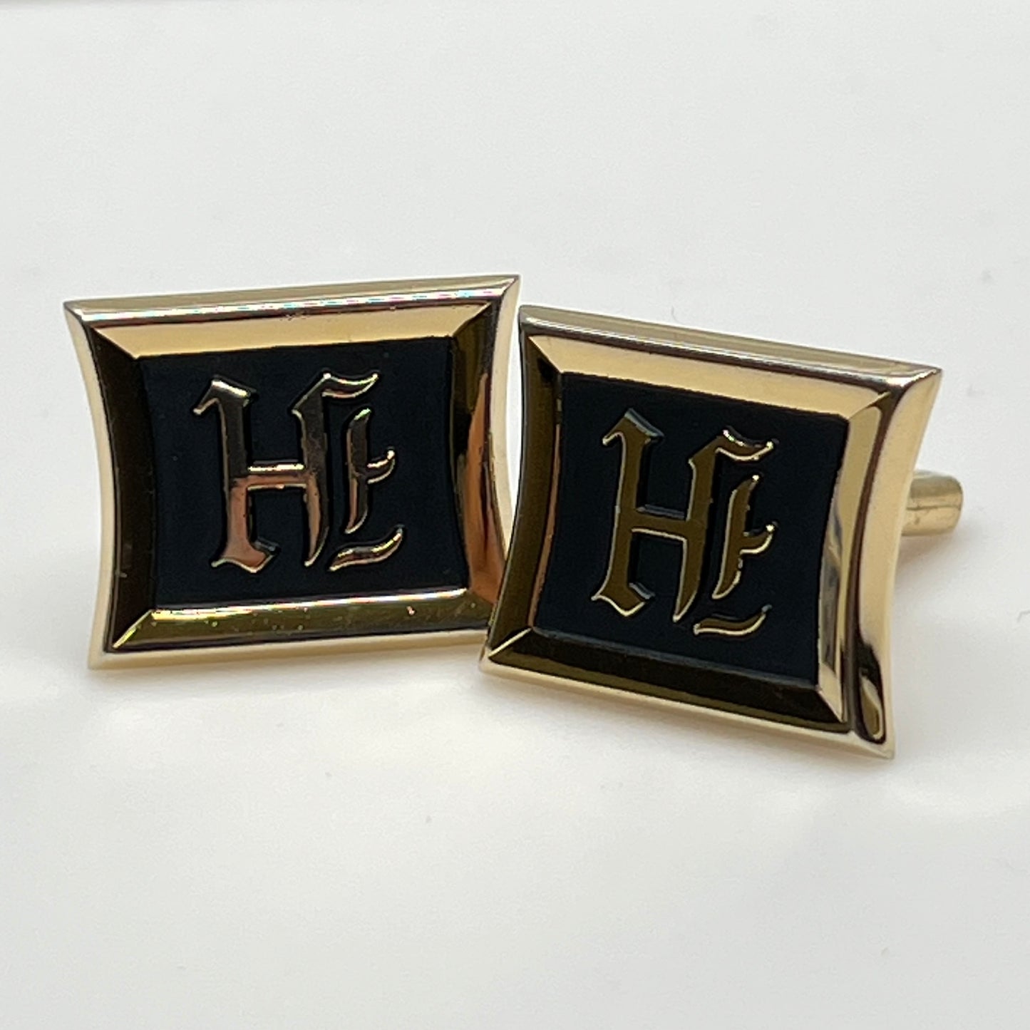 Rectangular gold cufflinks with black enamel and Gothic letter H