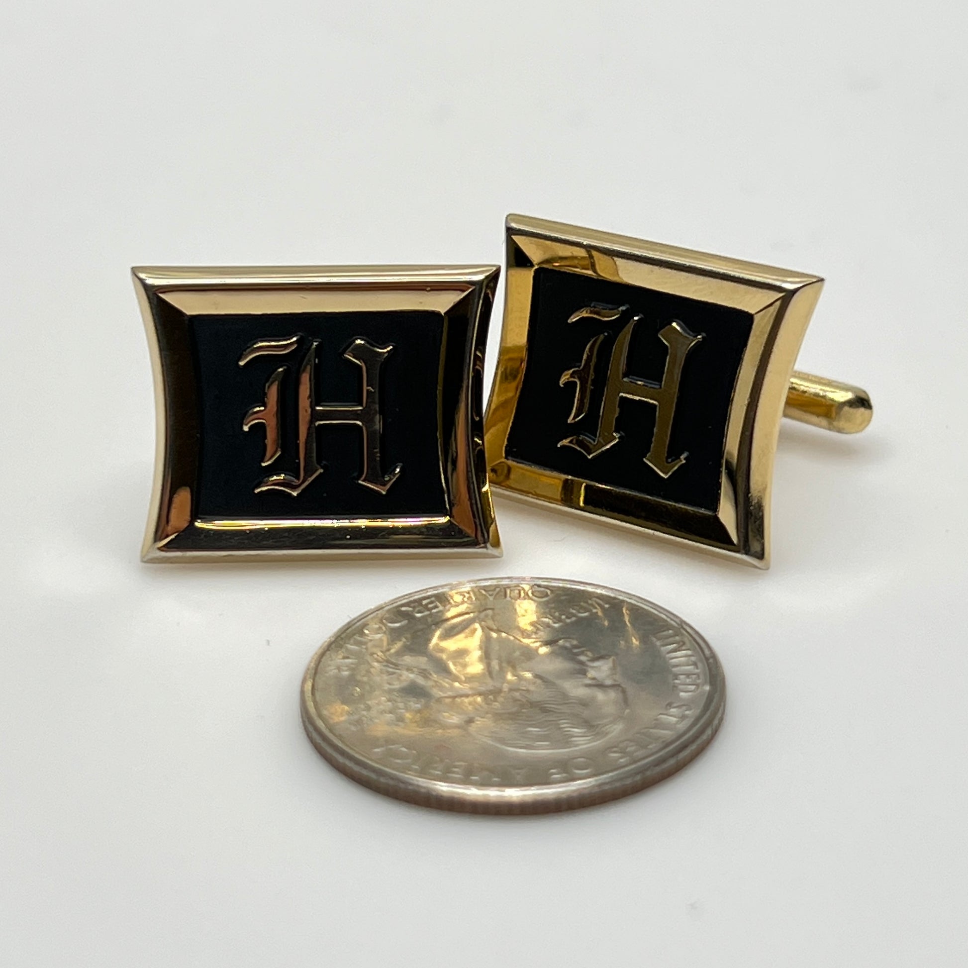 Rectangular gold cufflinks with black enamel and Gothic letter H