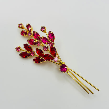Large gold-tone rhinestone brooch with red and pink stones in floral spray design