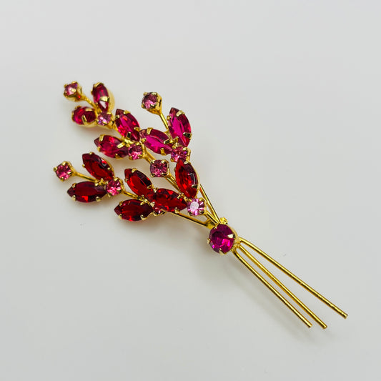 Large gold-tone rhinestone brooch with red and pink stones in floral spray design