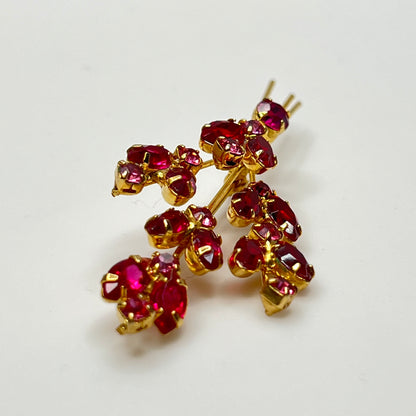 Large gold-tone rhinestone brooch with red and pink stones in floral spray design