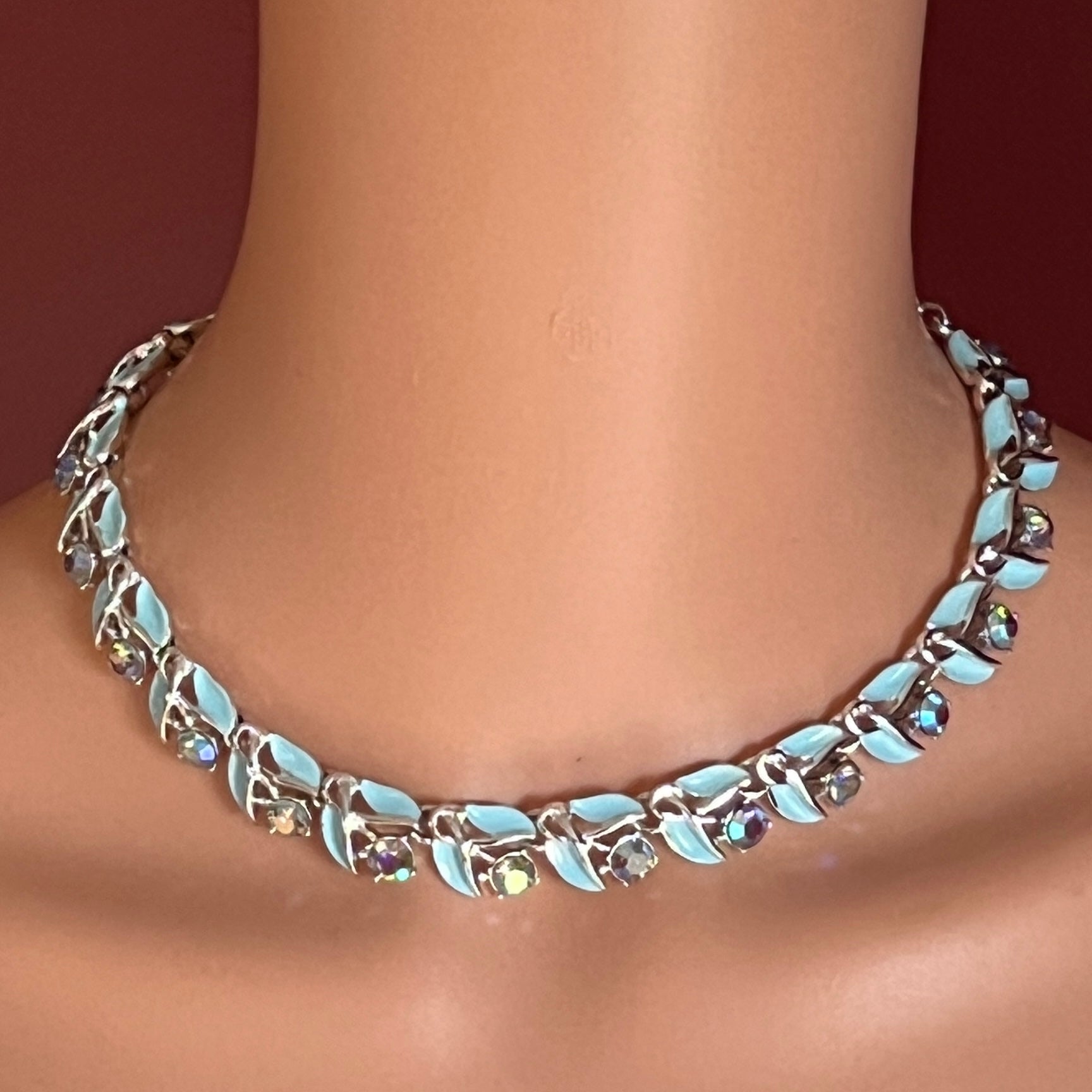 Blue enamel and rhinestone choker necklace modeled on neck