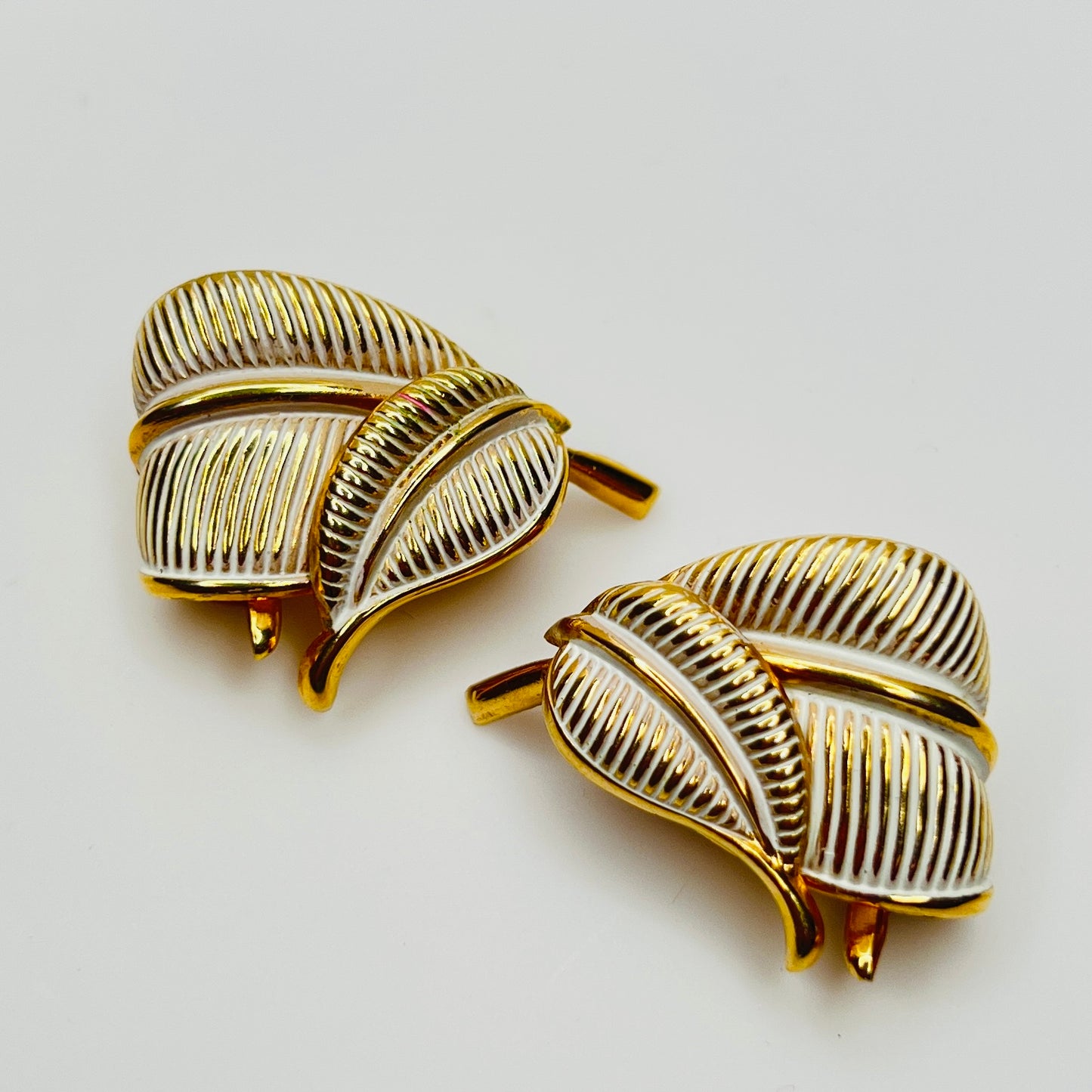 Vintage Kramer gold leaf clip on earrings with white enamel detail