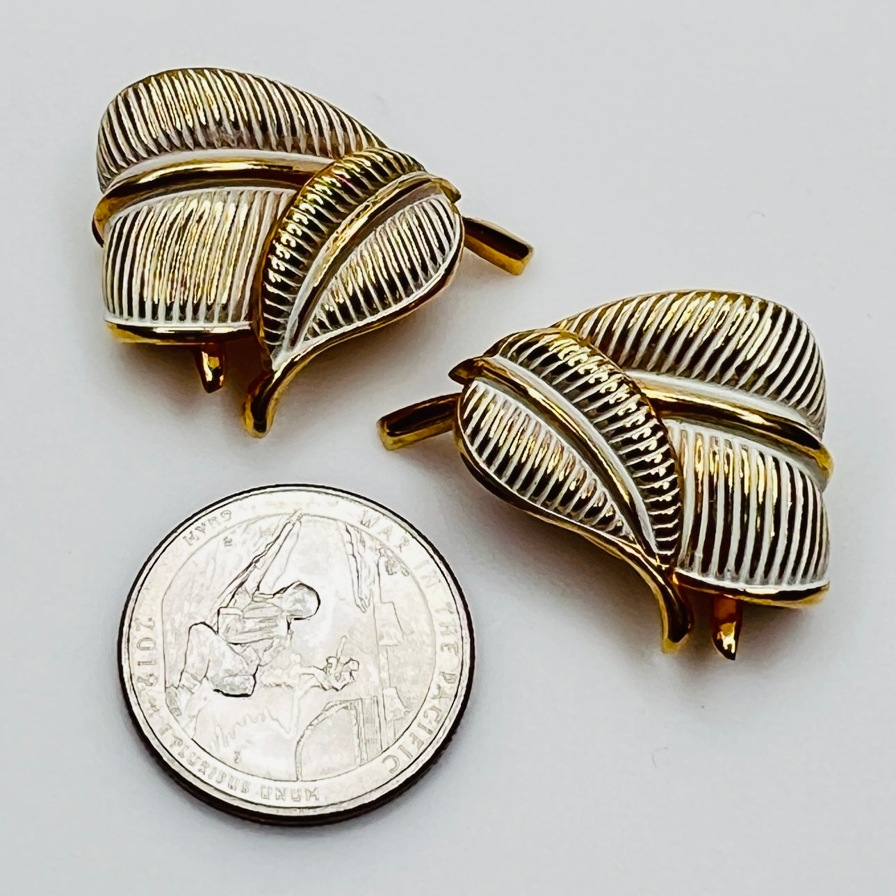 Vintage Kramer gold leaf clip on earrings with white enamel detail