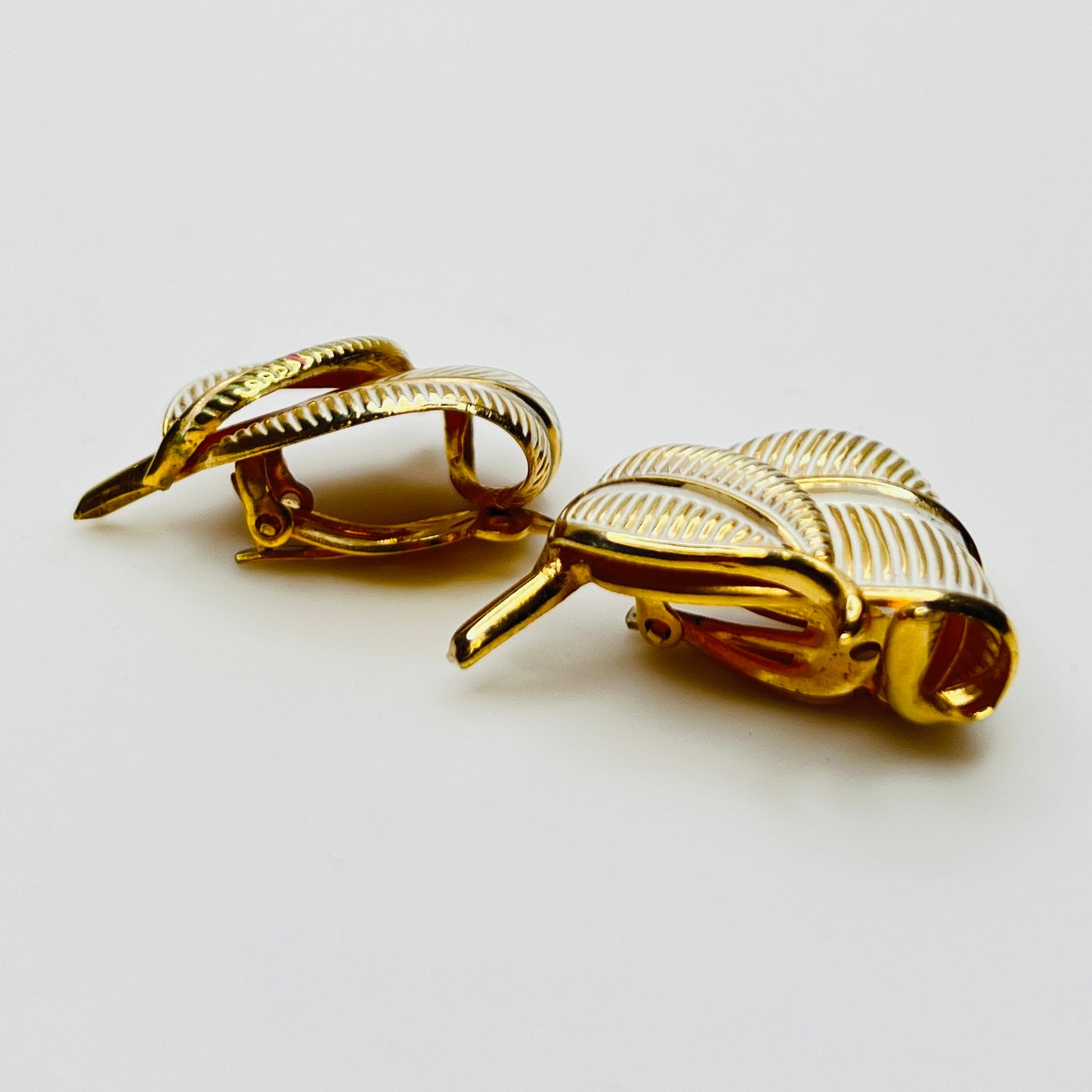 Side view vintage Kramer gold tone enamel leaf clip earrings