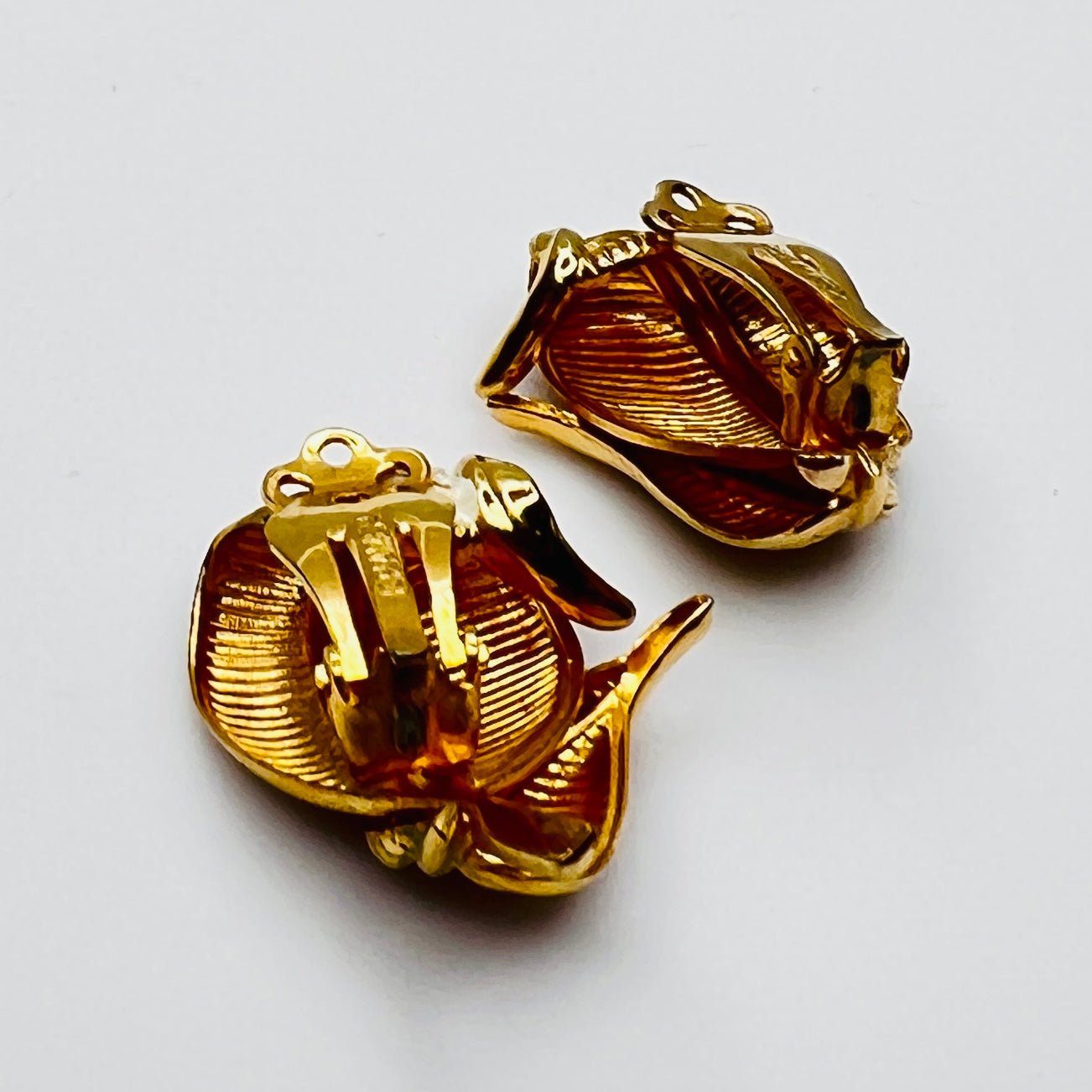 Side view vintage Kramer gold tone enamel leaf clip earrings