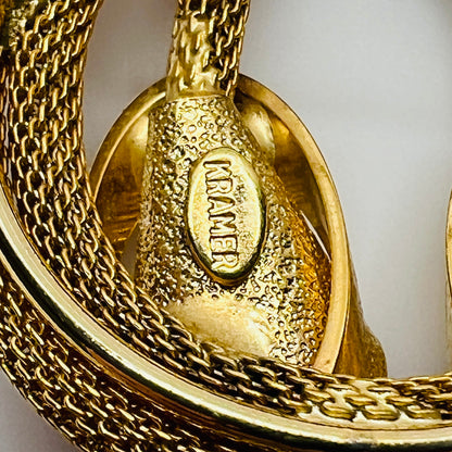 Close-up of Kramer signature on back of vintage gold brooch