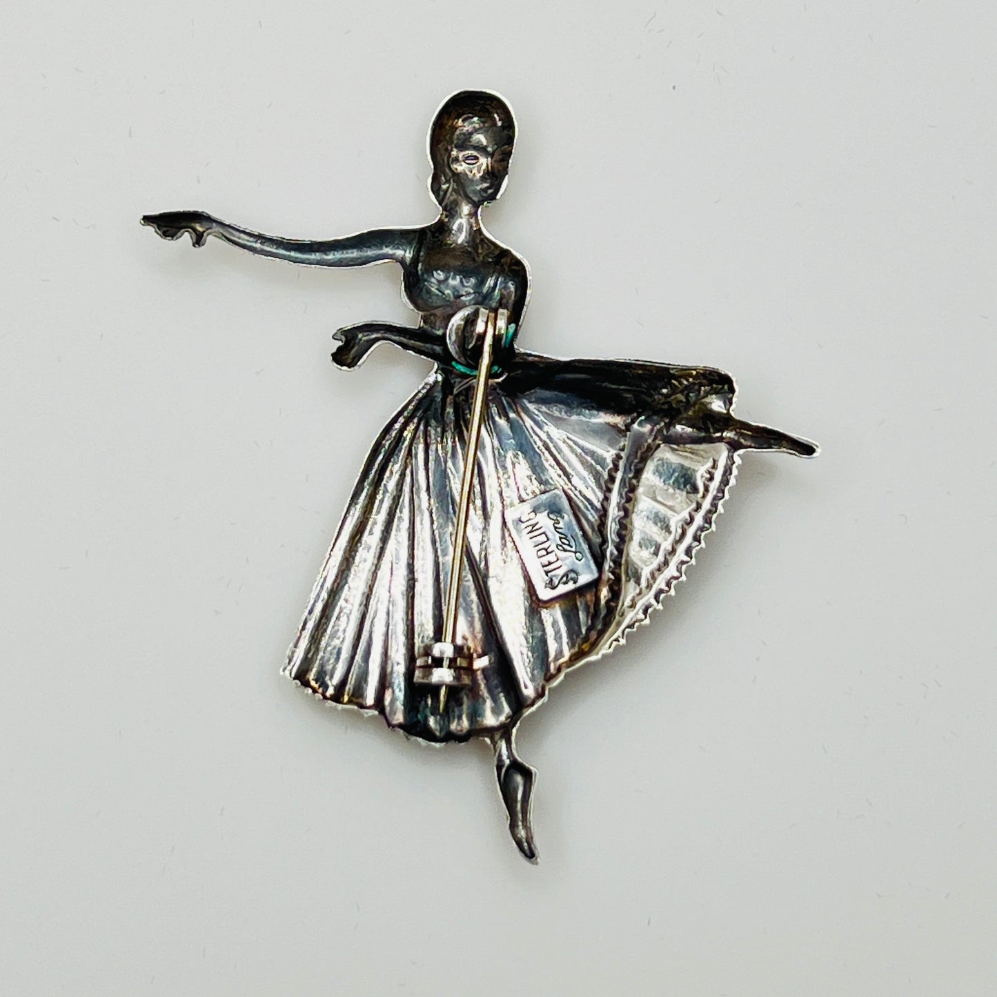 Back view showing “STERLING Lang” maker’s mark and pin clasp