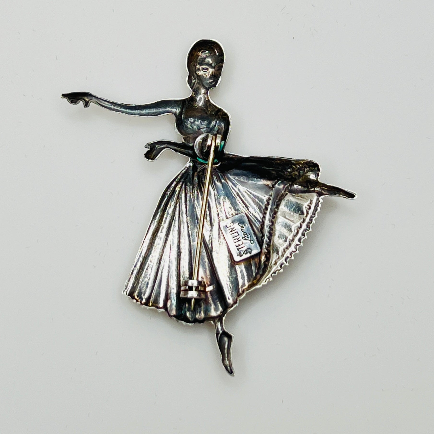 Back view showing “STERLING Lang” maker’s mark and pin clasp