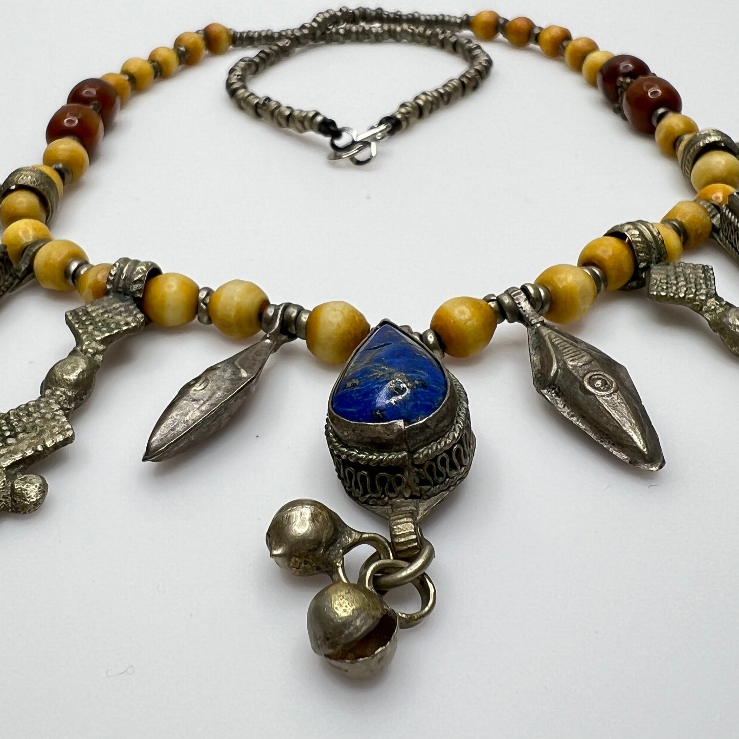 Close-up of lapis lazuli charms and mixed metal detailing