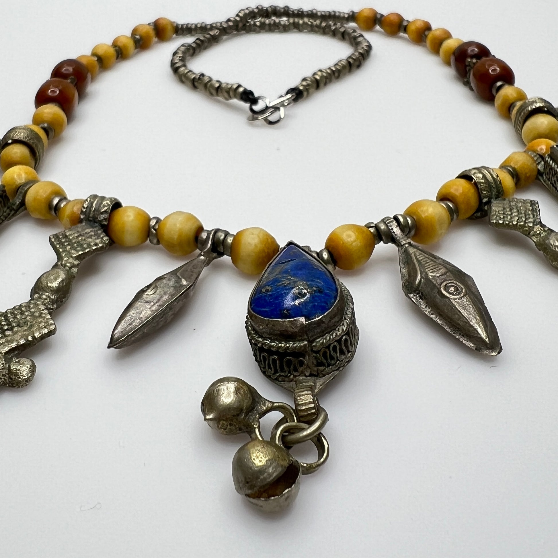 Close-up of lapis lazuli charms and mixed metal detailing