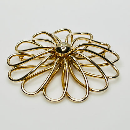 1960s statement flower brooch in polished gold metal