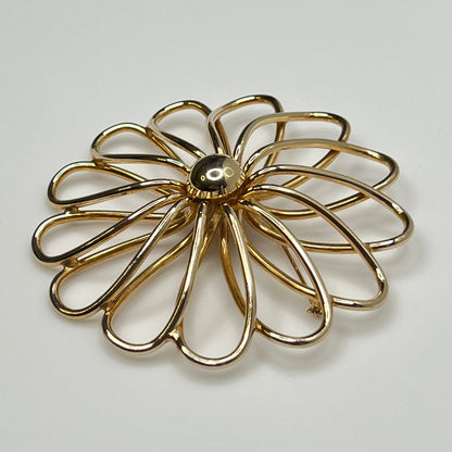 1960s statement flower brooch in polished gold metal