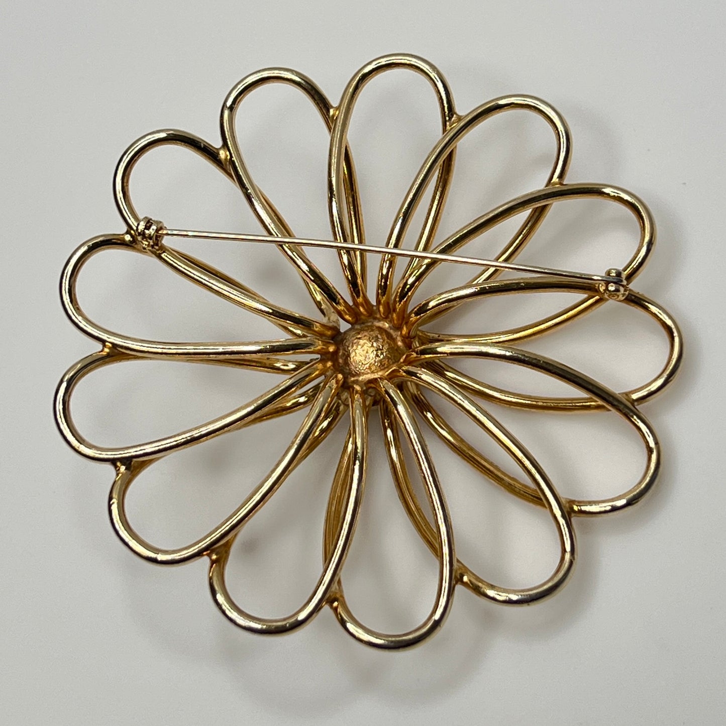 Large retro floral brooch with domed center and petal loops