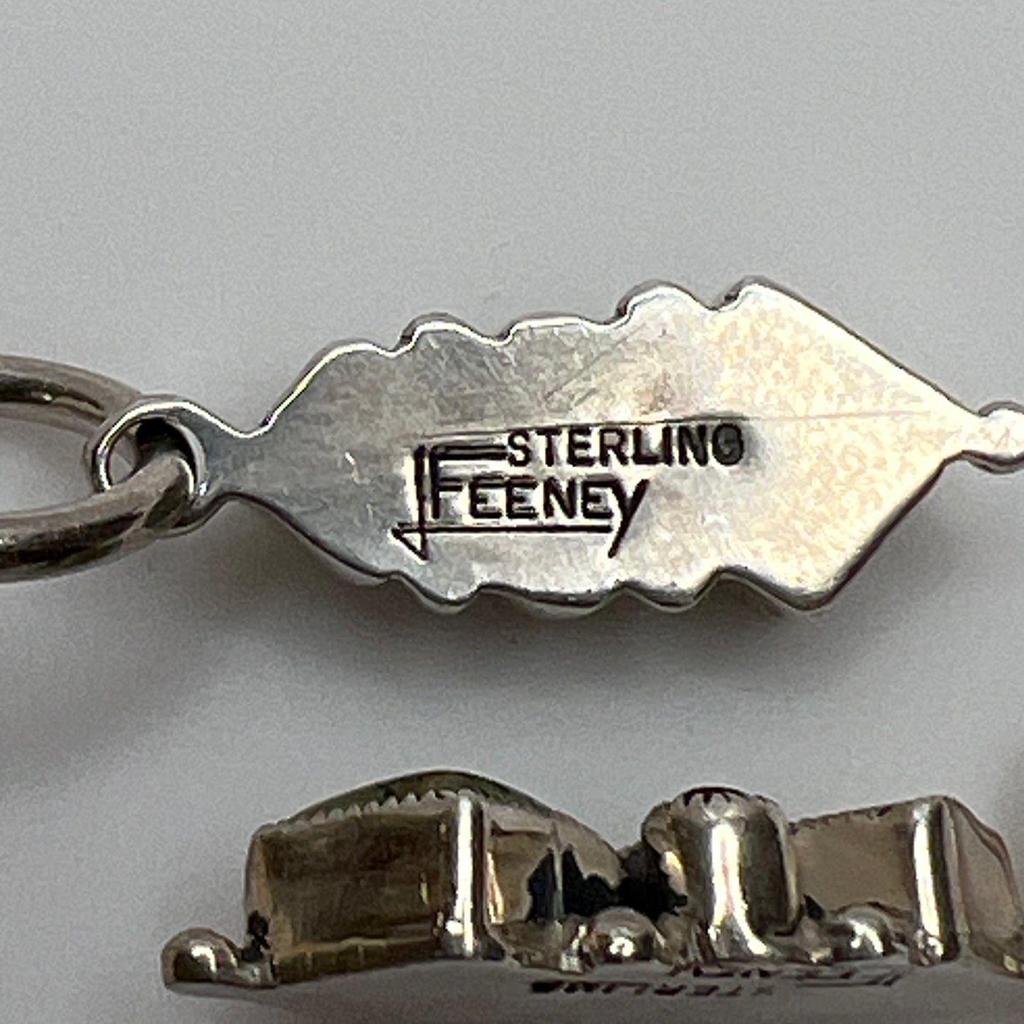 Sterling silver Leo Feeney earrings with peridot, turquoise, and black onyx dangle