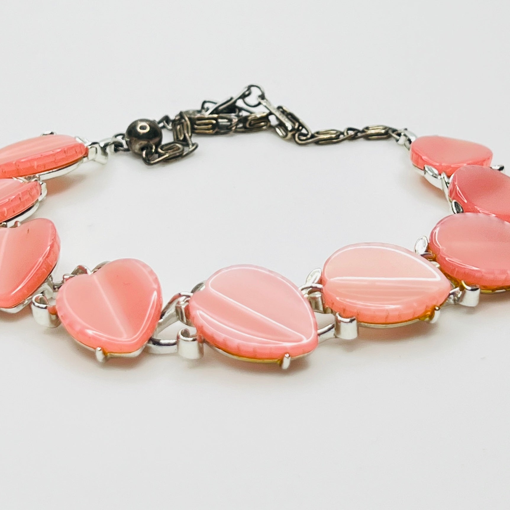 Close up of pink lucite leaf sections on vintage Lisner necklace