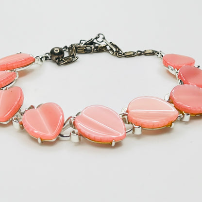 Close up of pink lucite leaf sections on vintage Lisner necklace