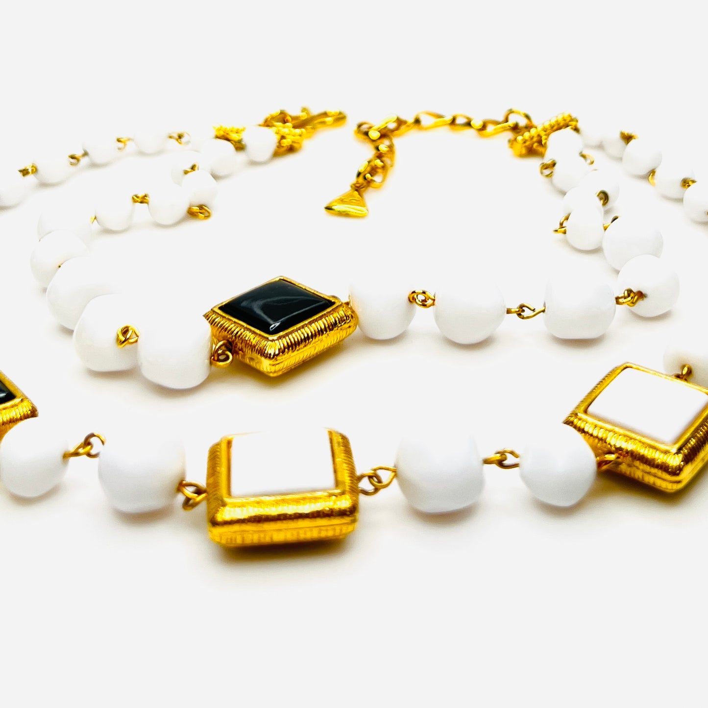 Close-up of Signed Liz Claiborne necklace and clip earring set with extender